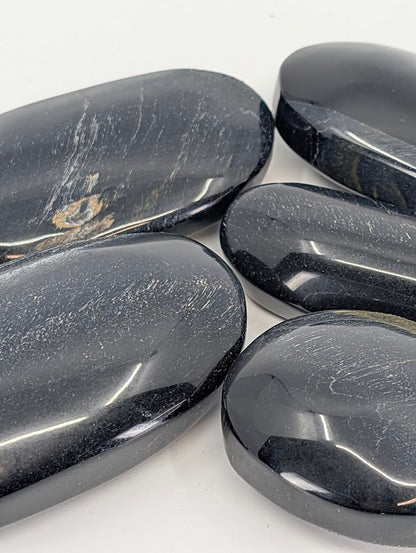 Close-up of Blue Tiger Eye Palm Stone highlighting chatoyance