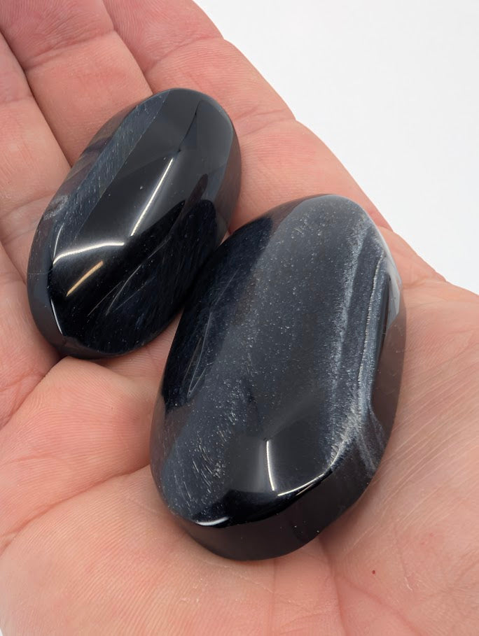 Blue Tiger Eye Palm Stones held in hand showing shimmer detail
