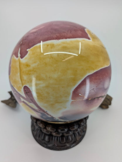 Detailed view of the natural mosaic pattern in the yellow brecciated section of a Mookaite sphere.