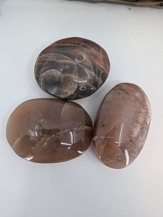 Brown moonstone palm stone polished showing earthy taupe feldspar tones