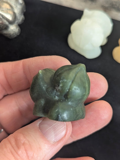Top down view of a hand-carved Bulbasaur focusing on the natural stone texture.