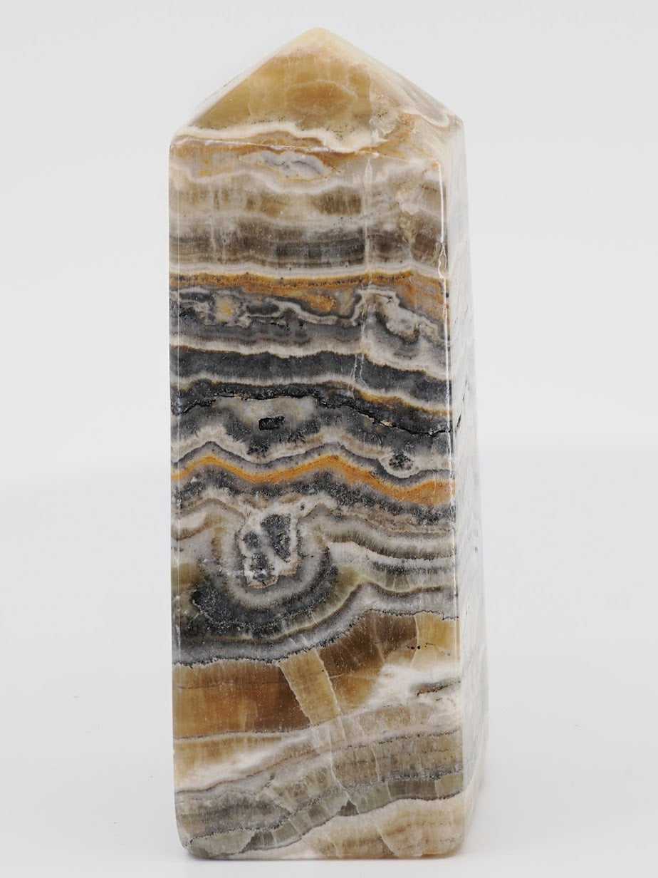 Polished Bumblebee Aragonite tower from Pakistan featuring vibrant yellow, white, and charcoal grey hydrothermal layers.