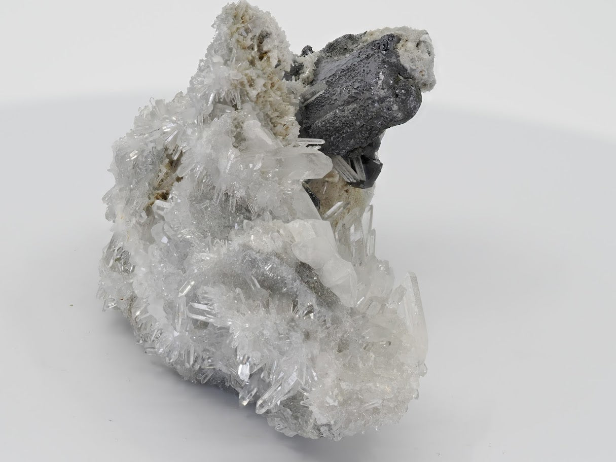 Isometric view of the full mineral specimen highlighting the structural balance of the galena base and quartz needles.