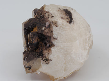 Base view of Calcite specimen showing white matrix attachment and natural rhombohedral cleavage planes.