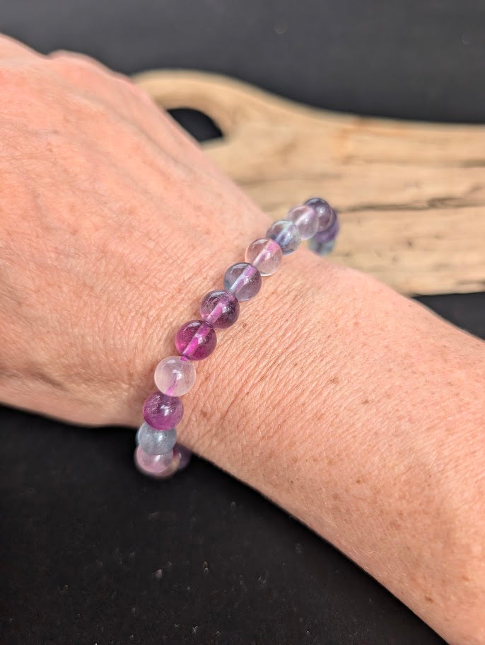 8mm Candy Fluorite beaded stretch bracelet worn on a wrist for size scale