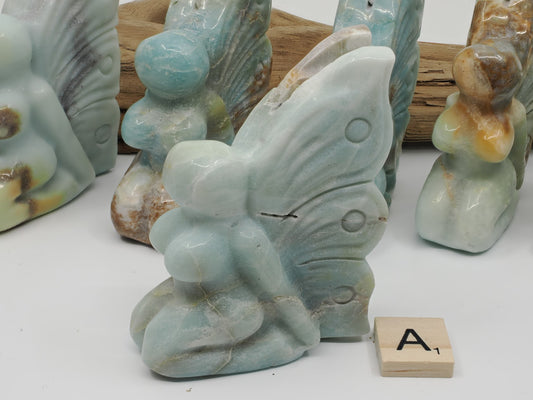 Side view of Caribbean Calcite Butterfly Fairy carving A showing soft seafoam blue and white aragonite.