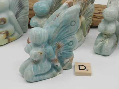 Saturated turquoise blue Caribbean Calcite fairy carving D with minimal brown inclusions.