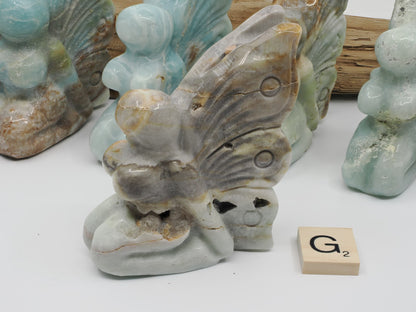 Textural Caribbean Calcite carving G featuring large natural druzy pockets and crystal apertures.