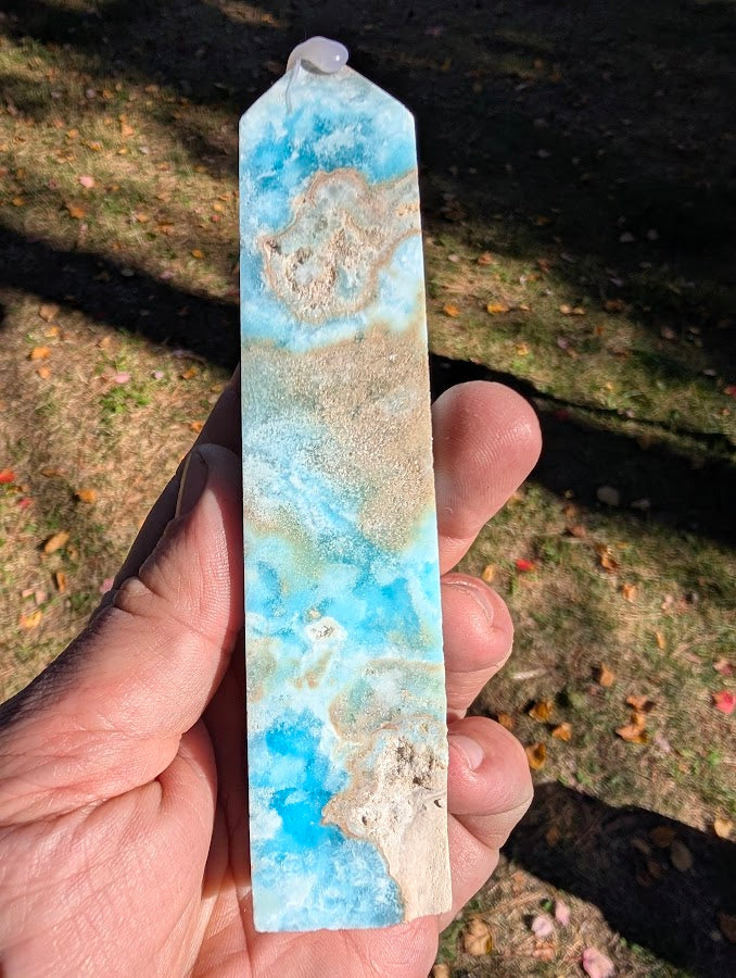 Caribbean Calcite Tower #6 front view — slender polished tower with aqua-blue calcite and aragonite