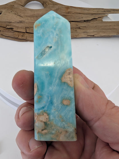 Handheld scale reference of Caribbean Calcite tower approximately 3 inches tall and 150 grams