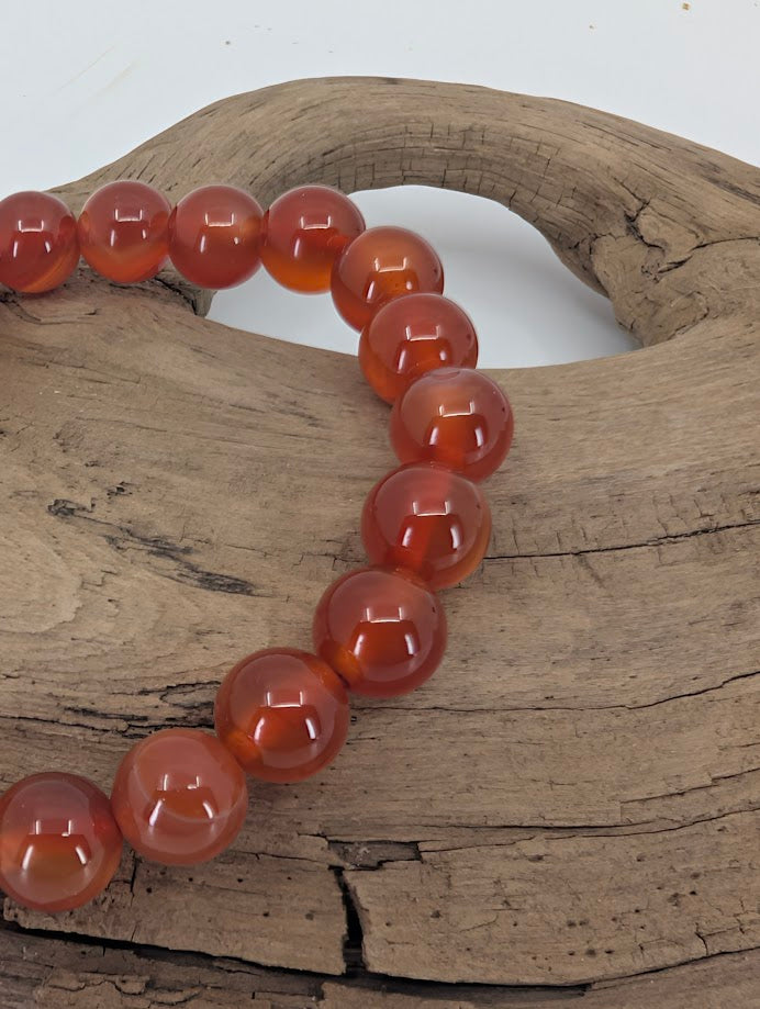 Close-up of AAA Carnelian bracelet showing high-gloss polish and even color saturation