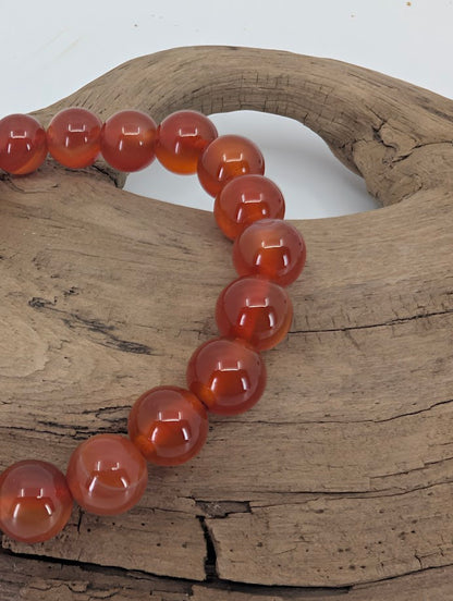 Close-up of AAA Carnelian bracelet showing high-gloss polish and even color saturation