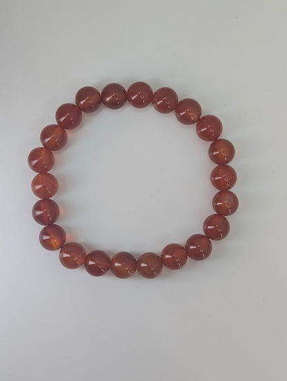 Premium Carnelian bracelet photographed in natural light highlighting inner clarity and glow