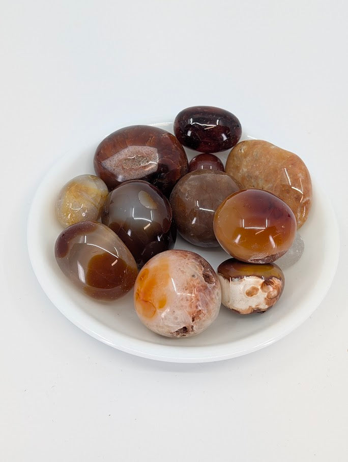 A-grade Carnelian tumbled stones in a bowl showing warm orange and red tones