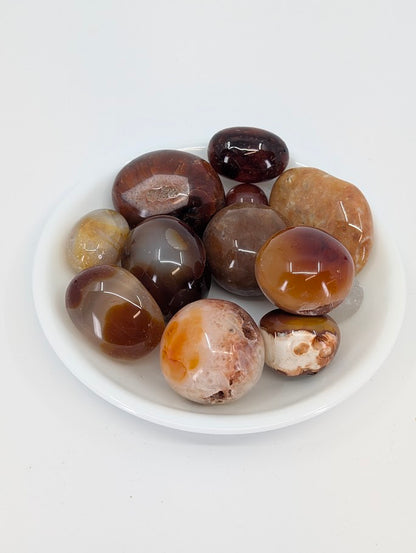 A-grade Carnelian tumbled stones in a bowl showing warm orange and red tones