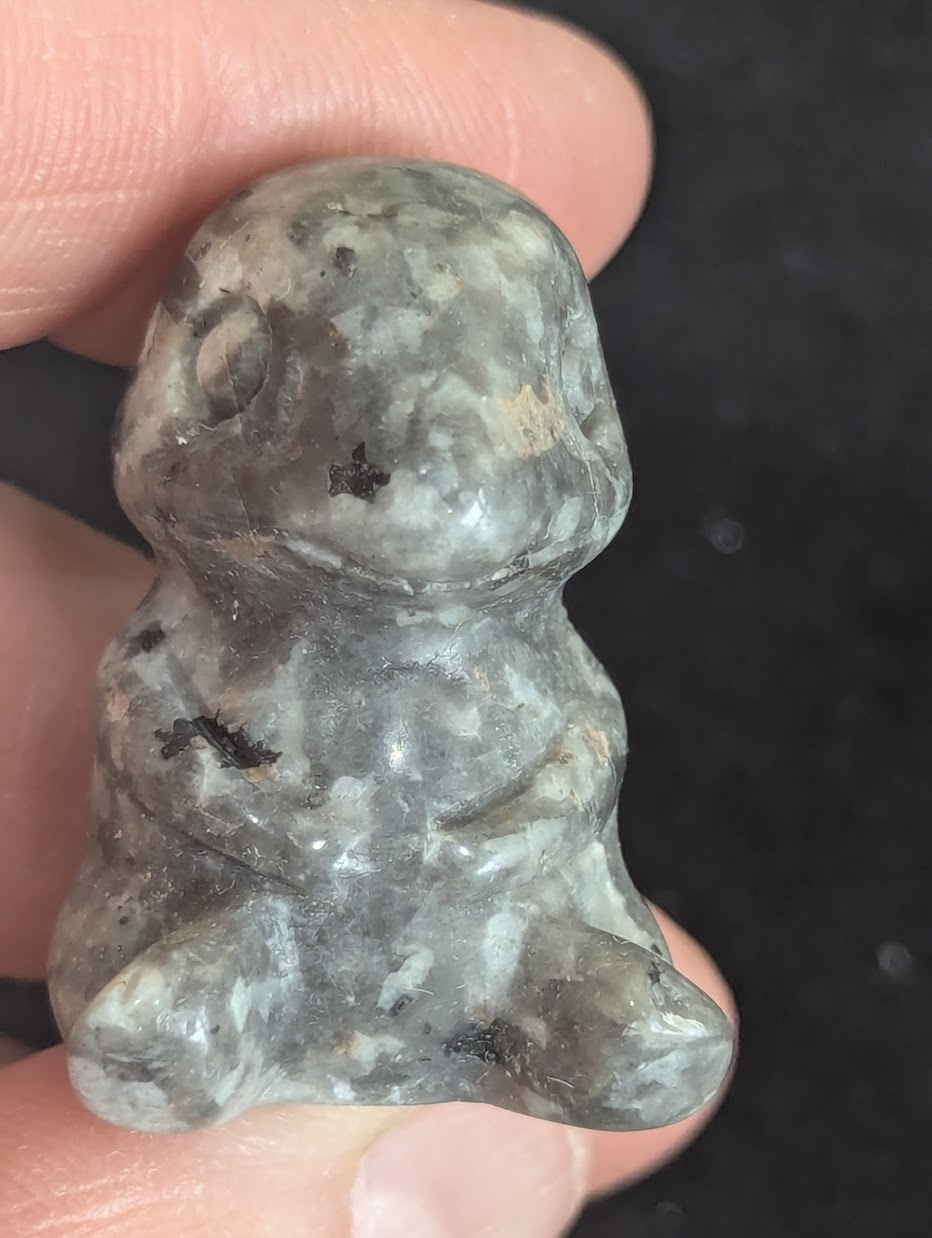 Frontal view of a hand-carved Labradorite Charmander showing the facial details.
