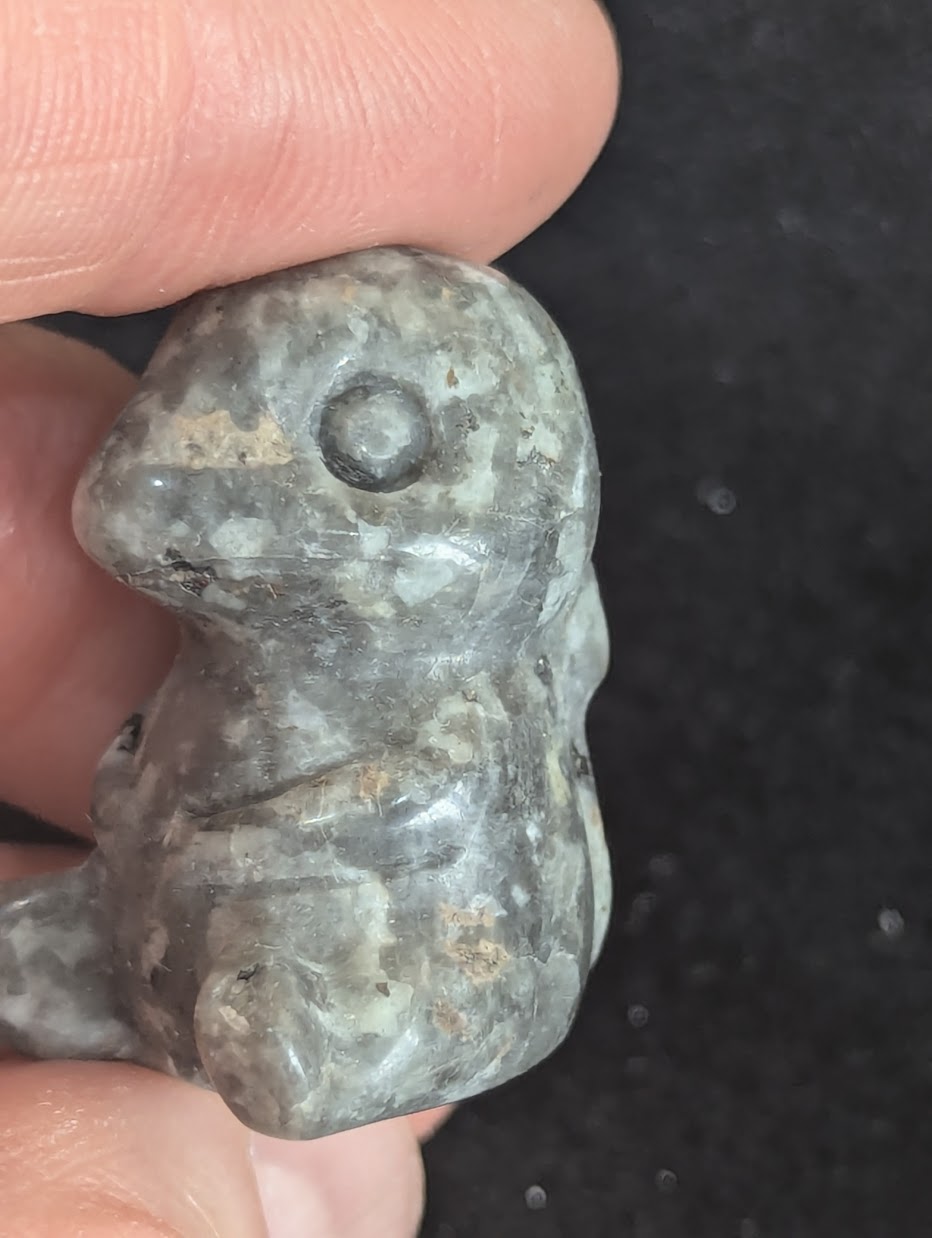 Close up view of the back and tail detail on a Labradorite Charmander carving.