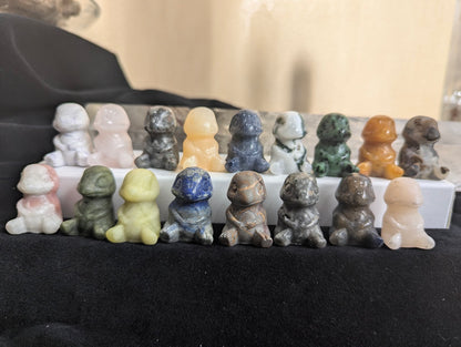 A large group of hand-carved Charmander Pokémon totems in various natural minerals.