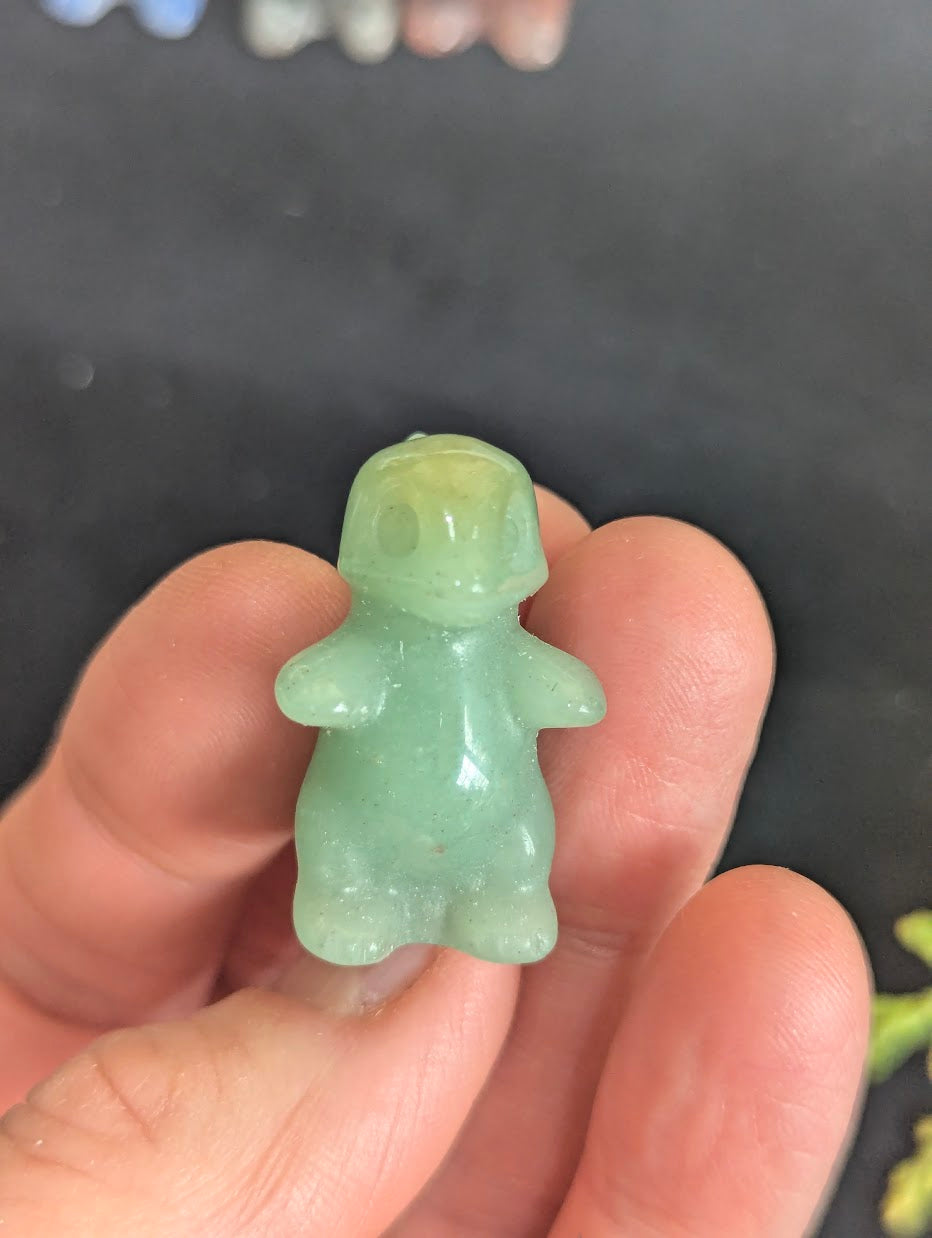 Front view of a 3cm Charmeleon carved from translucent Green Aventurine.