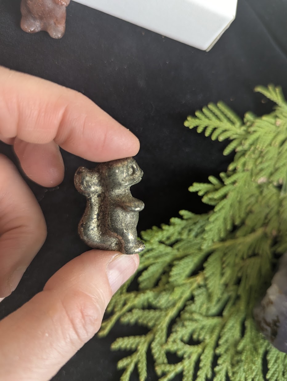 Rear view of a Pyrite Charmeleon carving showing the tail and crest details.