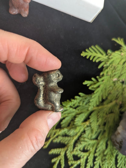 Rear view of a Pyrite Charmeleon carving showing the tail and crest details.