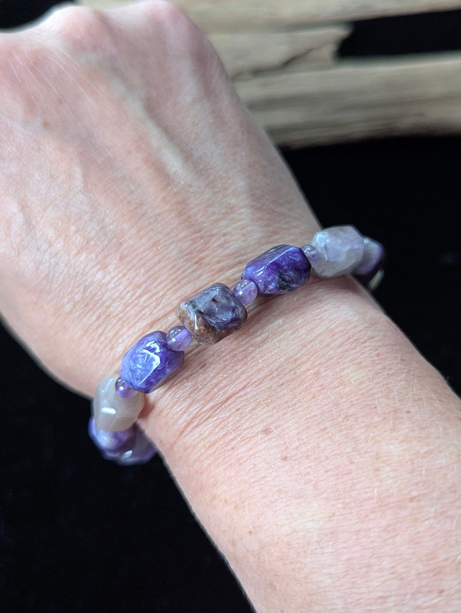 Charoite and Amethyst gemstone beaded bracelet styled on a wrist, highlighting its organic freeform shape and deep violet color palette.