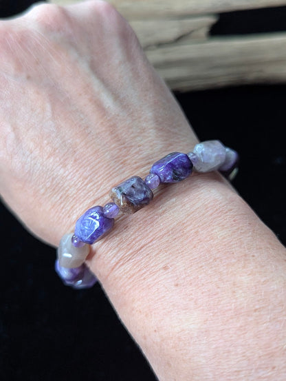 Charoite and Amethyst gemstone beaded bracelet styled on a wrist, highlighting its organic freeform shape and deep violet color palette.