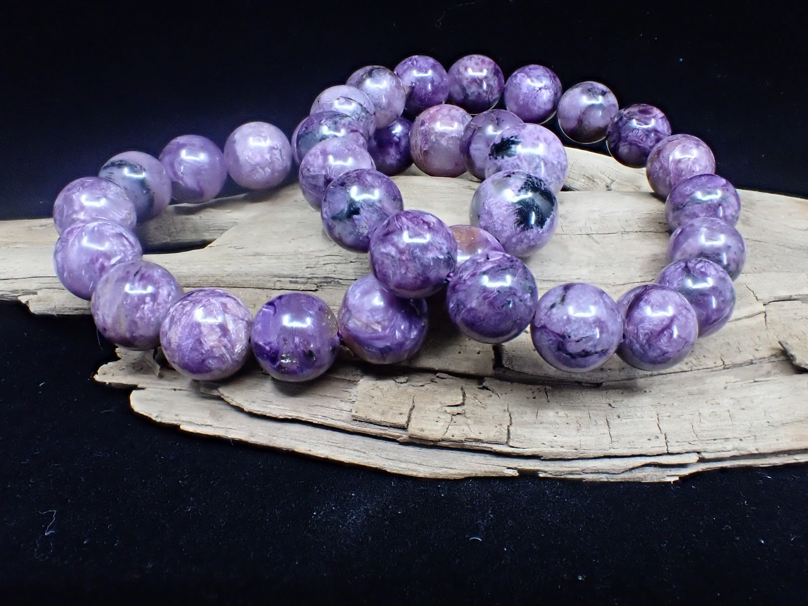 Comparison of medium and large Charoite gemstone beads showing size difference.