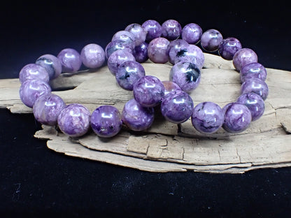 Comparison of medium and large Charoite gemstone beads showing size difference.