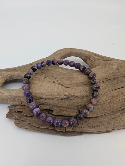 Charoite bracelet 6mm with natural violet swirls and black inclusions