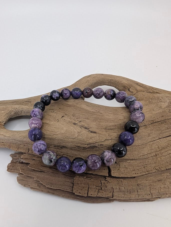 Charoite bracelet 8mm with natural violet swirls and black inclusions