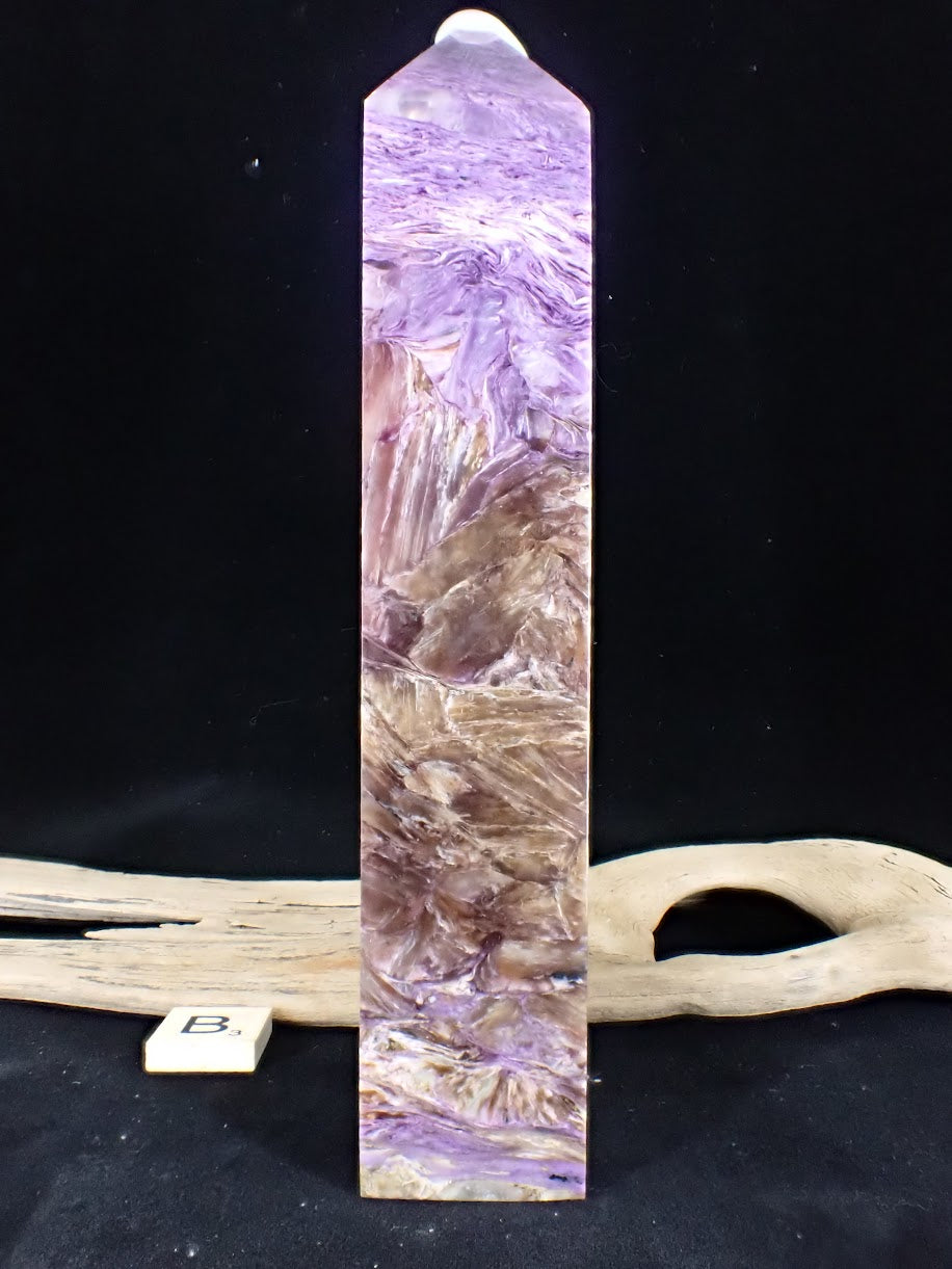 Detailed view of the 'river' effect where violet Charoite swirls around the hard matrix on Tower B.