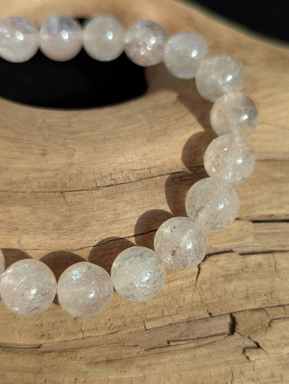 Macro photograph of 10mm Cherry Blossom Garden Quartz beads highlighting the delicate pink and white trace mineral inclusions.