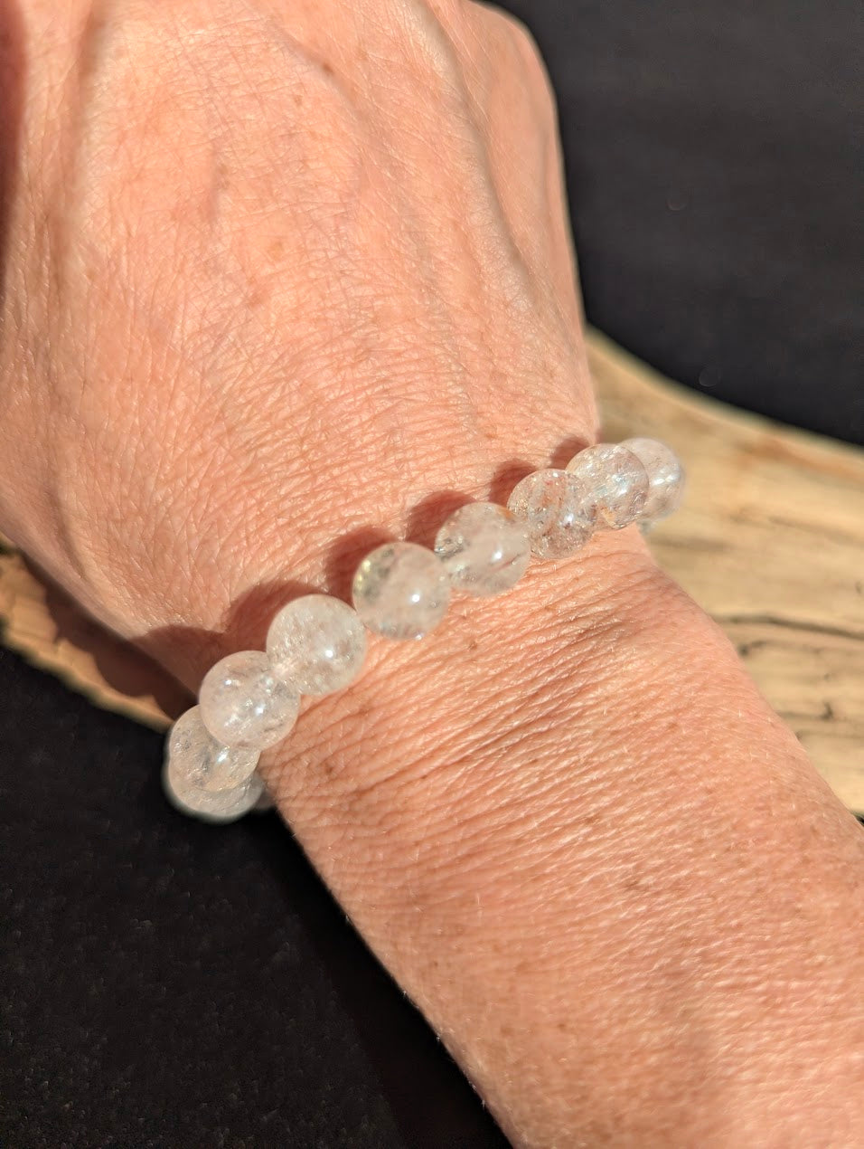 10mm AAA Grade Brazilian Cherry Blossom Garden Quartz beaded stretch bracelet worn on a wrist for scale demonstration.