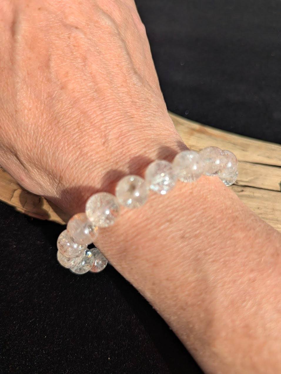 11mm AAA Grade Brazilian Cherry Blossom Garden Quartz beaded stretch bracelet worn on a wrist in natural sunlight.