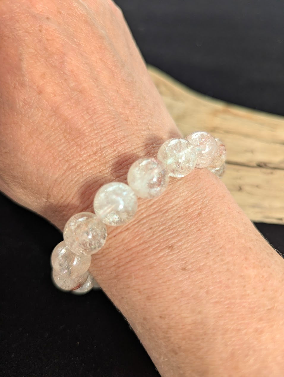 12mm AAA Grade Brazilian Cherry Blossom Garden Quartz beaded stretch bracelet worn on a wrist for scale.