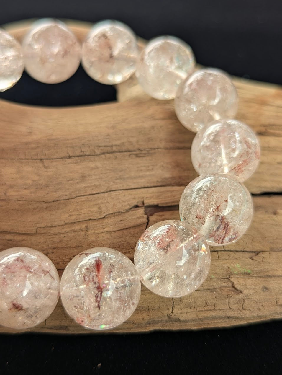 Macro detail of 16mm Cherry Blossom Garden Quartz beads capturing the ethereal pink and white internal mineral dustings and high vitreous lustre.