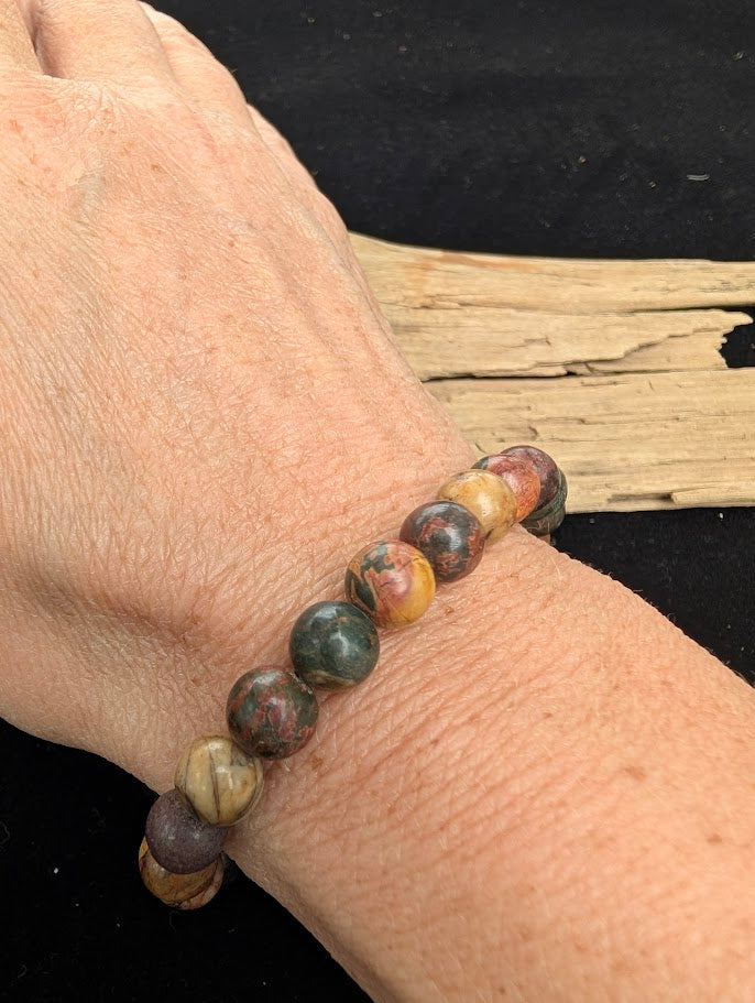 8mm polished Cherry Creek Jasper beaded stretch bracelet worn on a wrist for size scale.