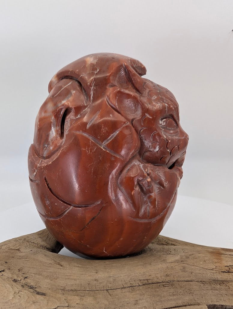 Angled view highlighting the artisan texture and cinnabar flow on the Chicken-blood Soapstone variant.