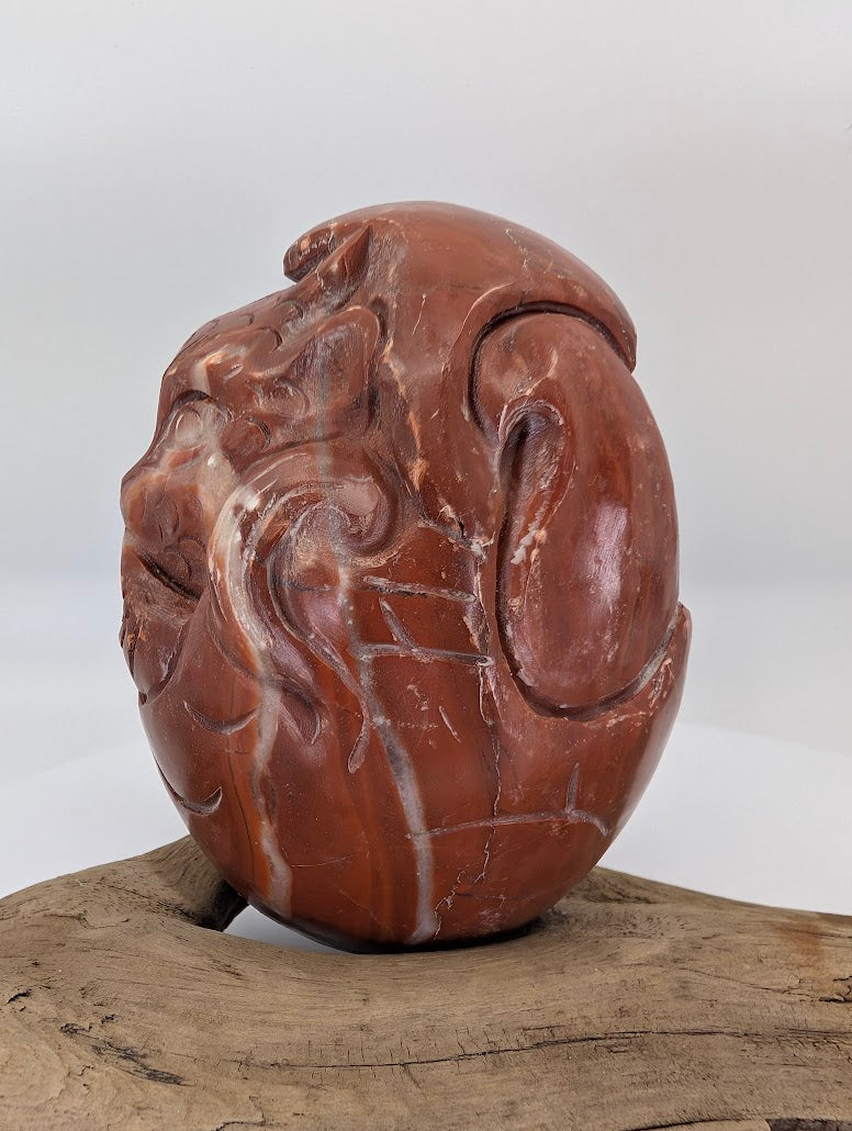 Side profile of the Chicken-blood Dragon showcasing the Fire element through its vibrant red color profile.