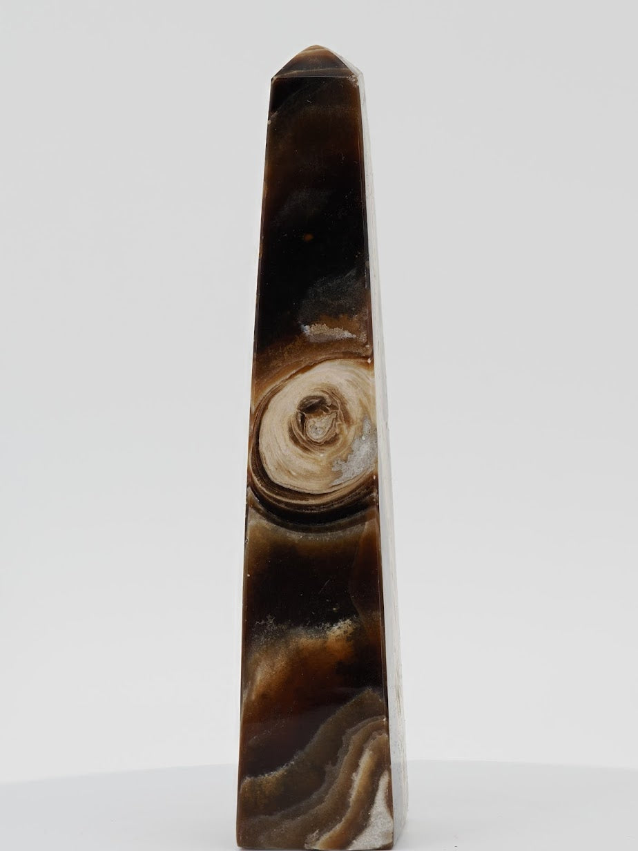 Polished Chocolate Banded Onyx tower from Pakistan featuring a unique circular orbital mineral "eye" and deep espresso bands.