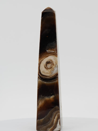Polished Chocolate Banded Onyx tower from Pakistan featuring a unique circular orbital mineral "eye" and deep espresso bands.