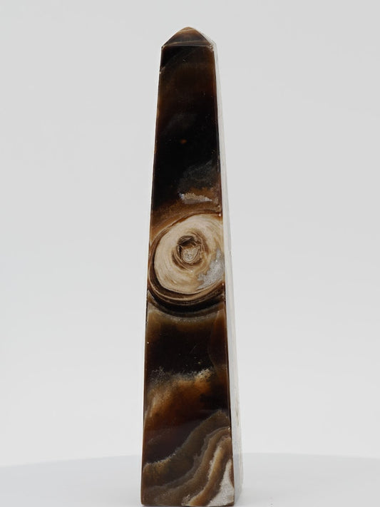 Polished Chocolate Banded Onyx tower from Pakistan featuring a unique circular orbital mineral "eye" and deep espresso bands.