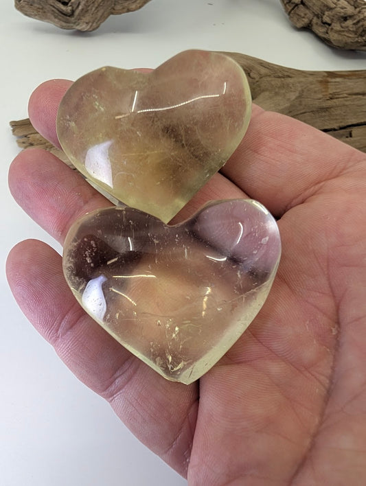 Hand-held Natural Citrine Heart (55g) from Congo, showcasing size and rich golden-champagne color.