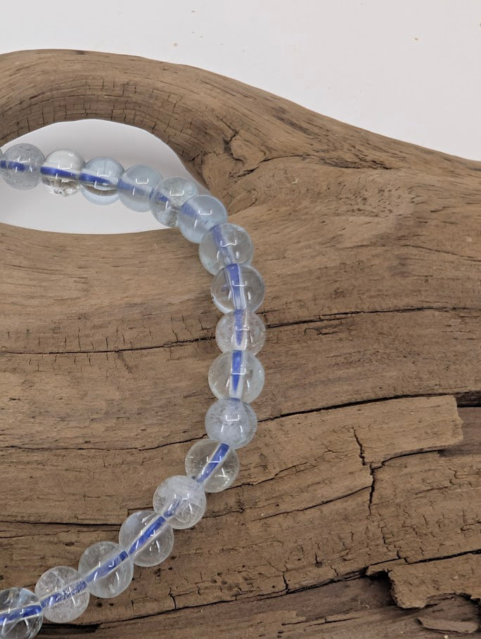 Close-up of clear aquamarine beads showing natural clarity