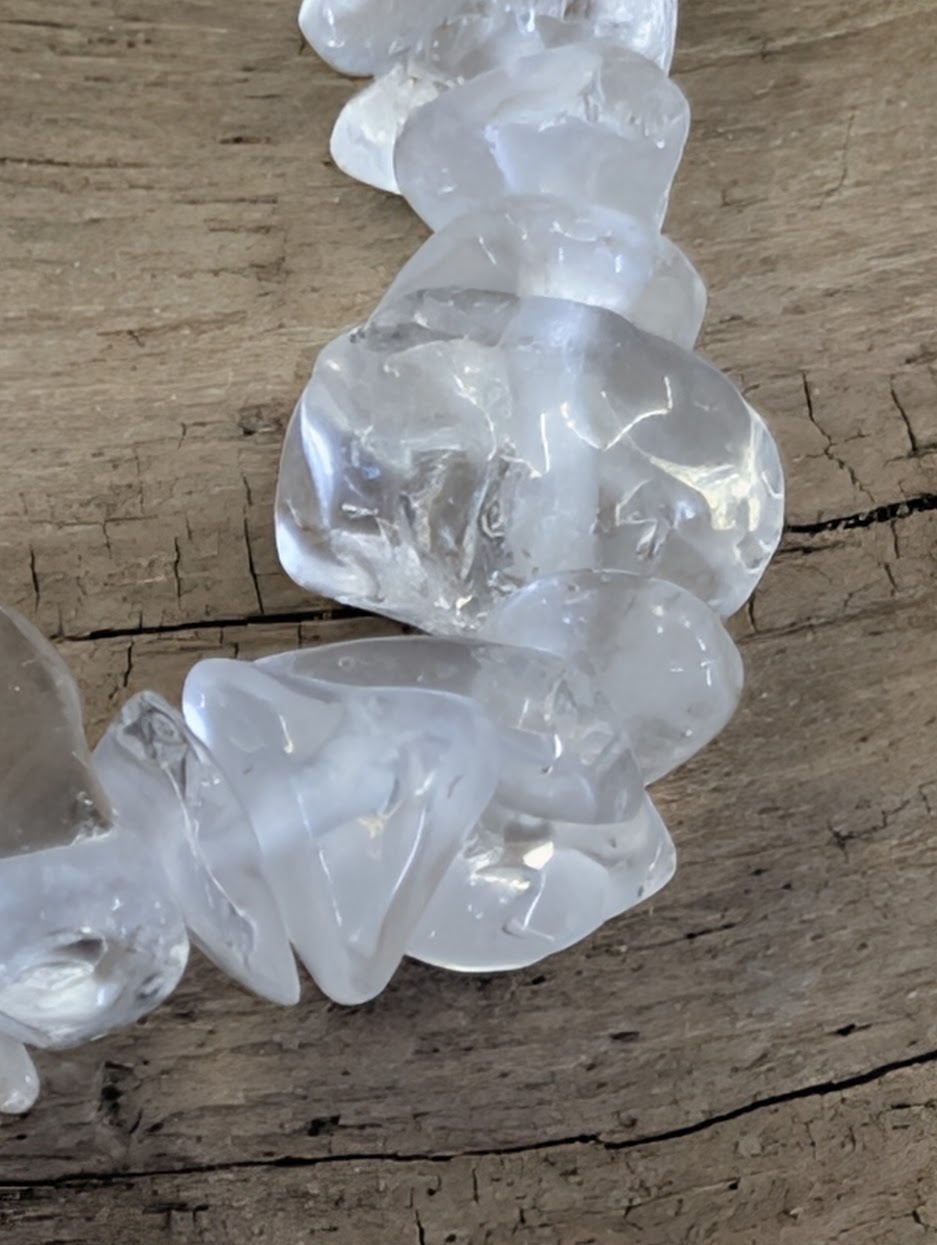 Close-up of water-clear calcite tumbled chips highlighting the "frozen ice" aesthetic and high clarity.