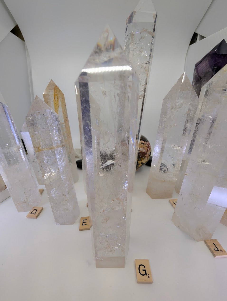 Polished 23cm Clear Quartz tower (CQT-G) highlighting deep internal fracture planes and excellent refractive qualities.