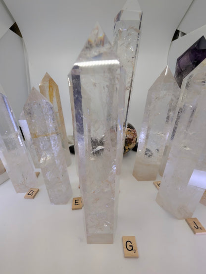 Polished 23cm Clear Quartz tower (CQT-G) highlighting deep internal fracture planes and excellent refractive qualities.