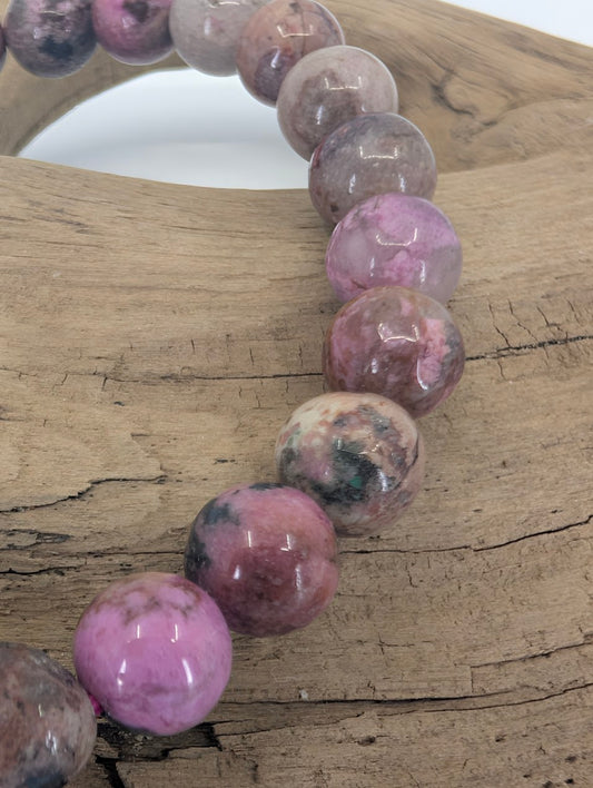 Closeup of pink Cobaltoan Calcite beads showing natural mottling