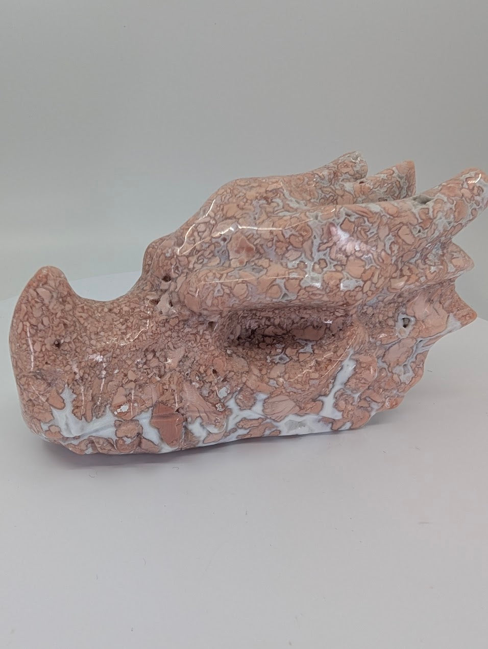 Side profile of Cotton Candy Agate Dragon Head Variant B showing brecciated pink agate and chalcedony flow